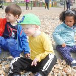 children sat on the pebbles