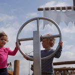 2 students holding onto a wheel