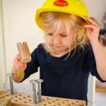 Child with hammer and nail