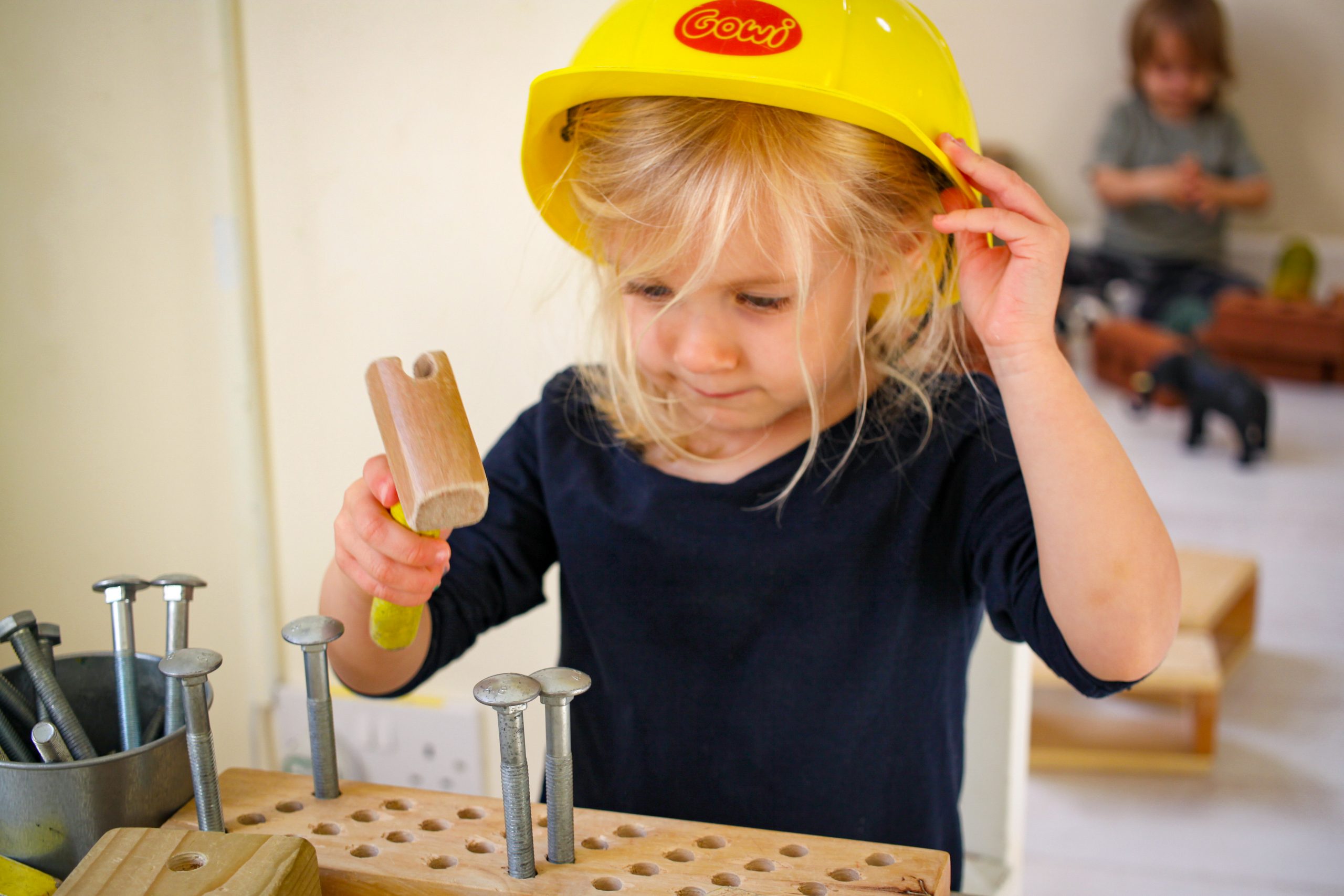 Child with hammer and nail