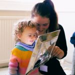 Educator and child looking at reflections