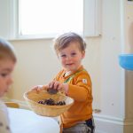 Child with pinecone