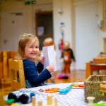 Child smiling while reading