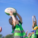 boy catching rugby ball