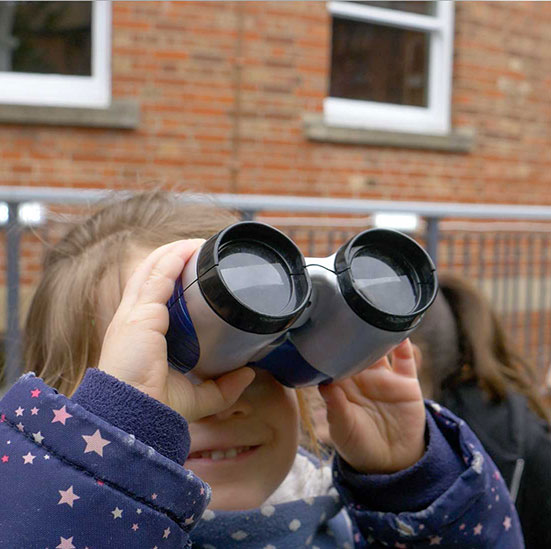 girl looking through binoculars