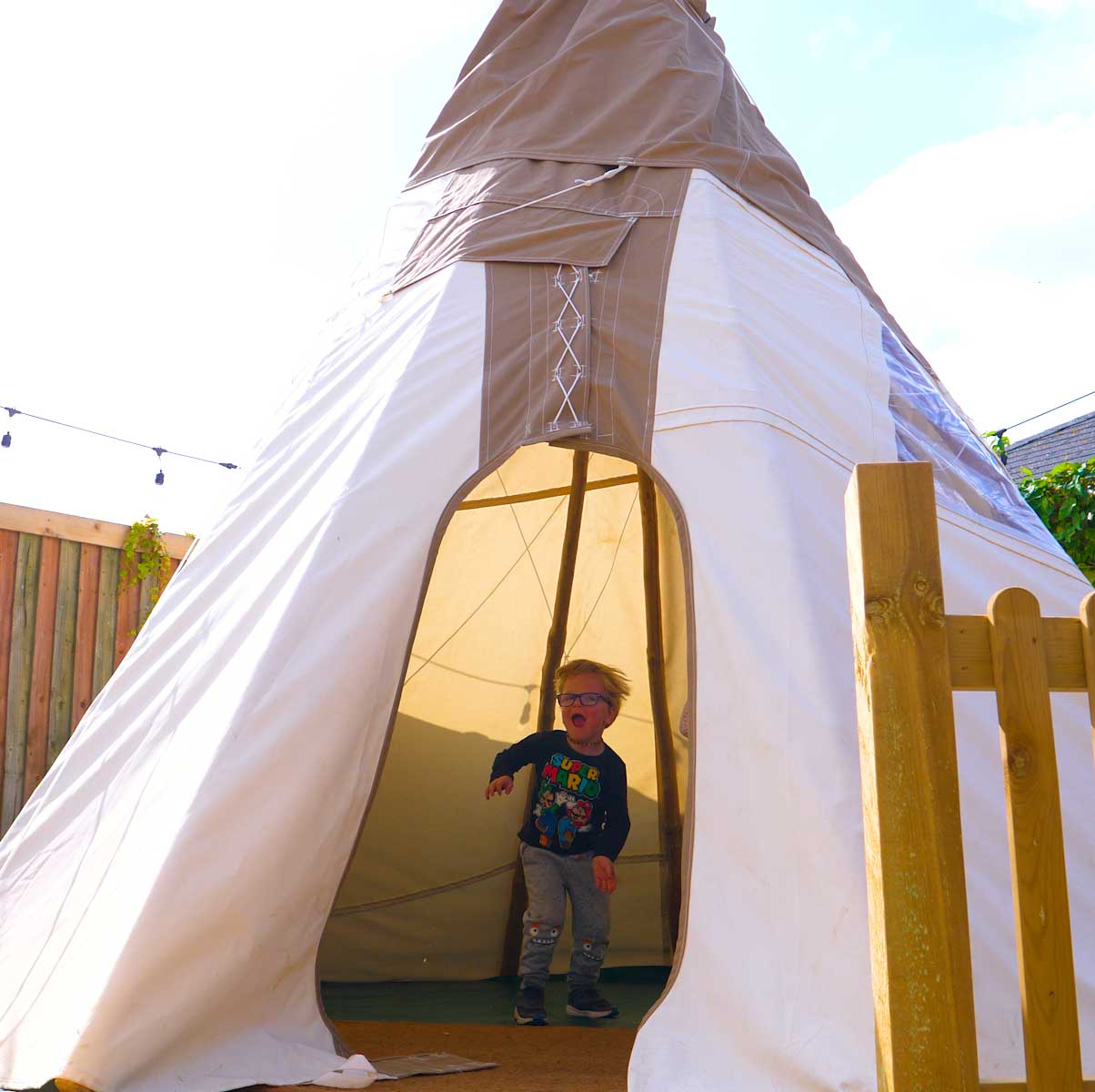 boy jumping in teepee