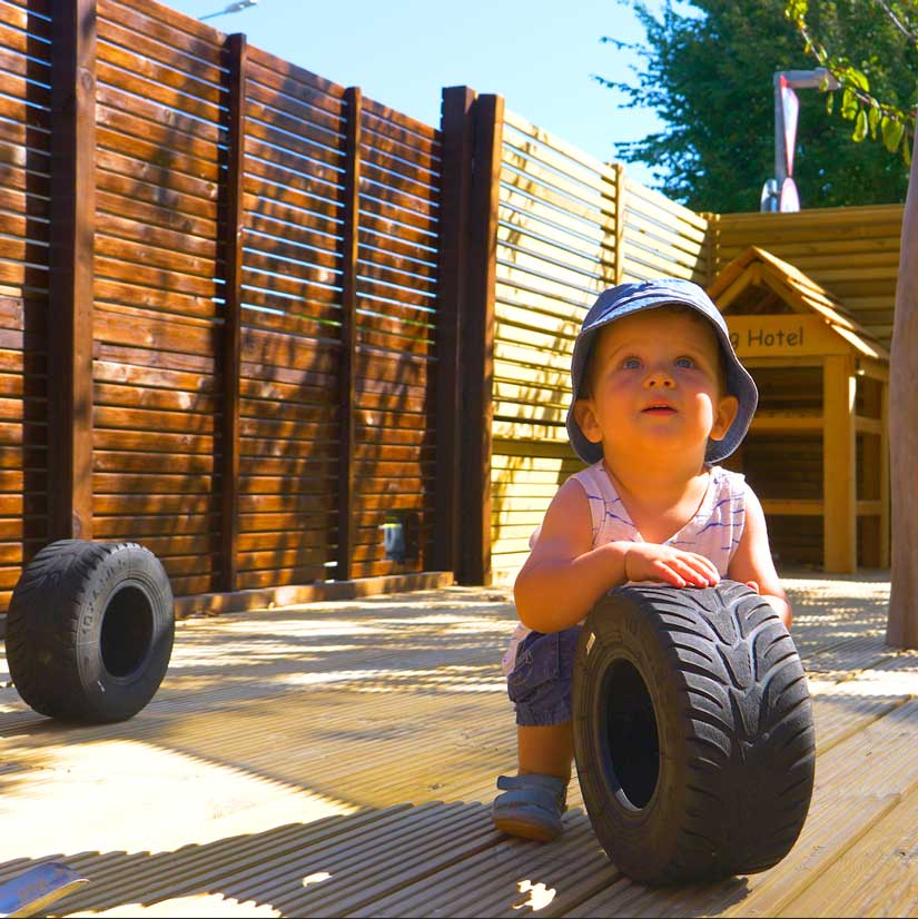 boy with mini tyre in baby garden