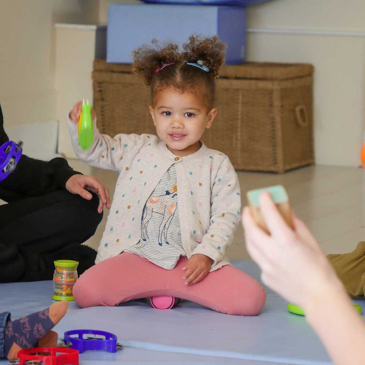 SQUARE-girl-sat-on-crash-mat-holding-musical-instrument-2