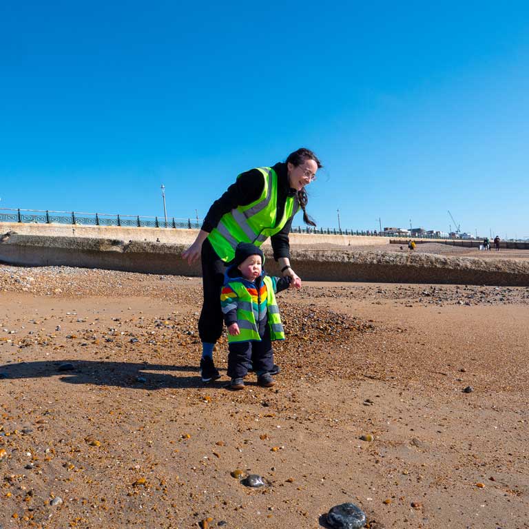 educator and child on beach